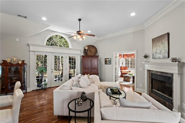 living room with dark hardwood / wood-style floors, a fireplace, lofted ceiling, ornamental molding, and ceiling fan