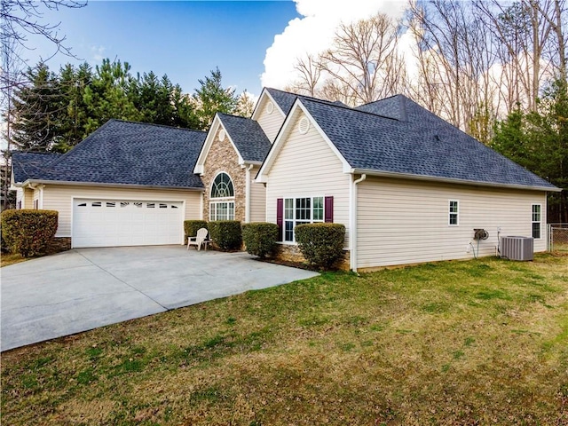 view of front of property featuring central AC, a front yard, a garage, stone siding, and driveway