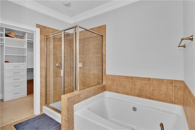 bathroom with a stall shower, ornamental molding, tile patterned flooring, a spacious closet, and a bath