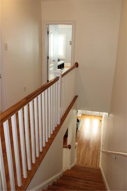 stairway with wood finished floors