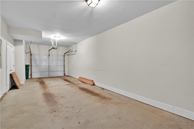 garage featuring a garage door opener and baseboards