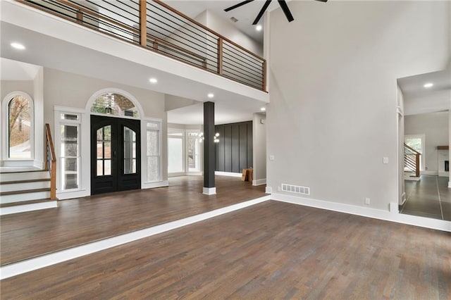 1066 Fairway Valley Dr, Woodstock, GA 30189 - entryway featuring a towering ceiling, a ceiling fan, stairs, wood finished floors, and french doors