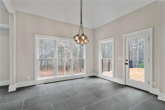 1066 Fairway Valley Dr, Woodstock, GA 30189 - unfurnished dining area featuring dark tile patterned flooring, baseboards, and a chandelier