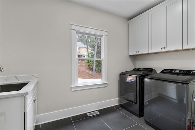 1066 Fairway Valley Dr, Woodstock, GA 30189 - laundry room featuring washer and dryer, cabinet space, dark tile patterned floors, and baseboards