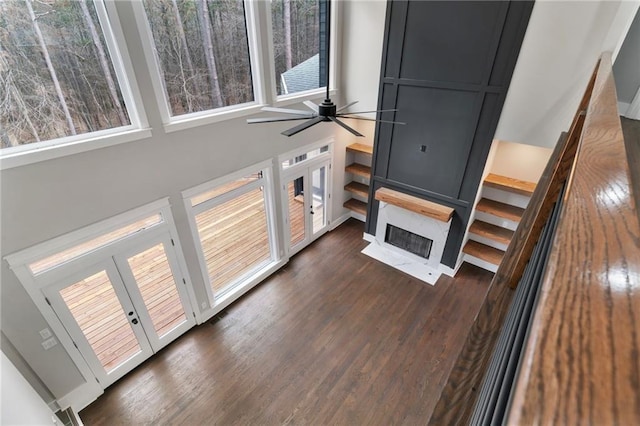 1066 Fairway Valley Dr, Woodstock, GA 30189 - unfurnished living room with dark wood-style flooring, healthy amount of natural light, and a large fireplace