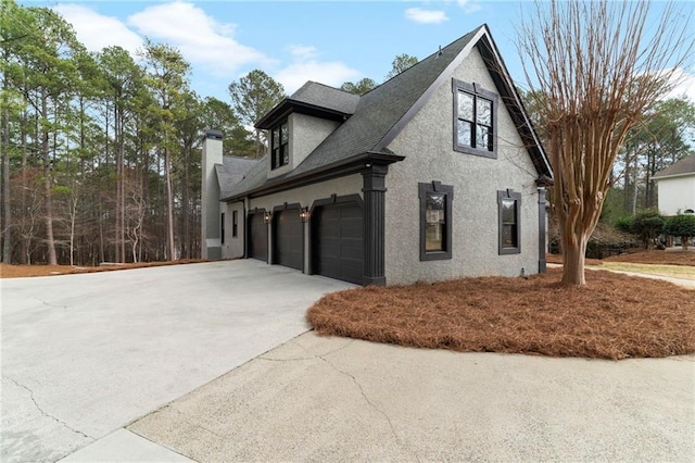 1066 Fairway Valley Dr, Woodstock, GA 30189 - view of property exterior featuring concrete driveway, stucco siding, roof with shingles, and a chimney