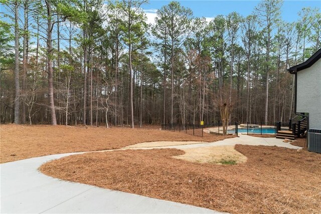 1066 Fairway Valley Dr, Woodstock, GA 30189 - view of yard featuring an outdoor pool and central AC unit