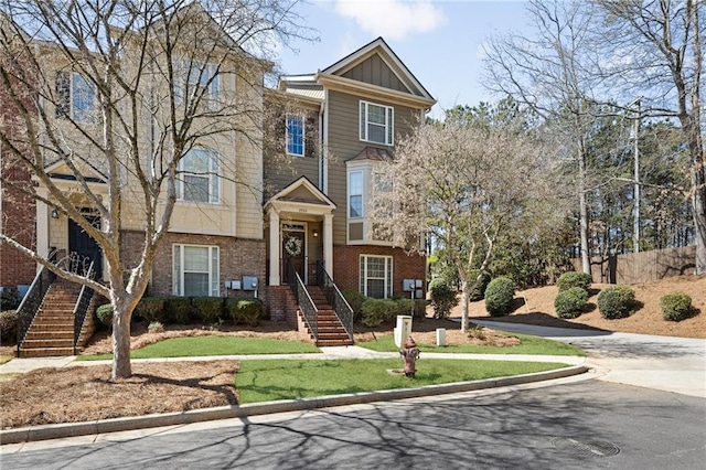 townhome / multi-family property with board and batten siding and brick siding