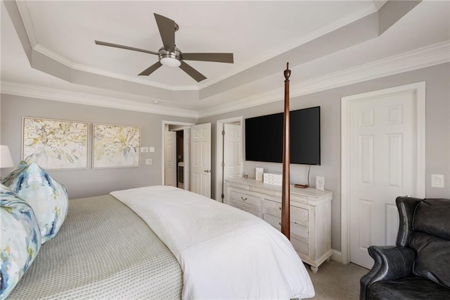 bedroom with a raised ceiling, crown molding, and light colored carpet