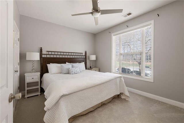bedroom with visible vents, baseboards, a ceiling fan, and carpet flooring