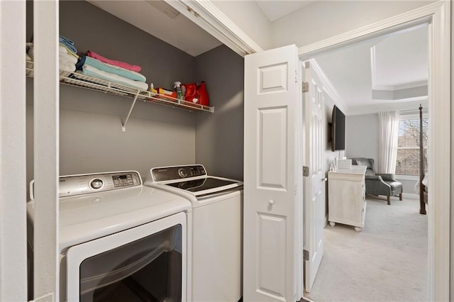 laundry area with light carpet, laundry area, independent washer and dryer, and ornamental molding