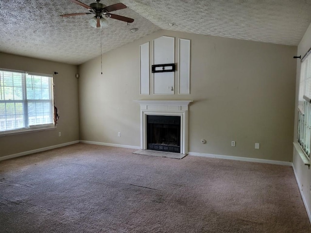 unfurnished living room featuring ceiling fan, a textured ceiling, carpet floors, and vaulted ceiling