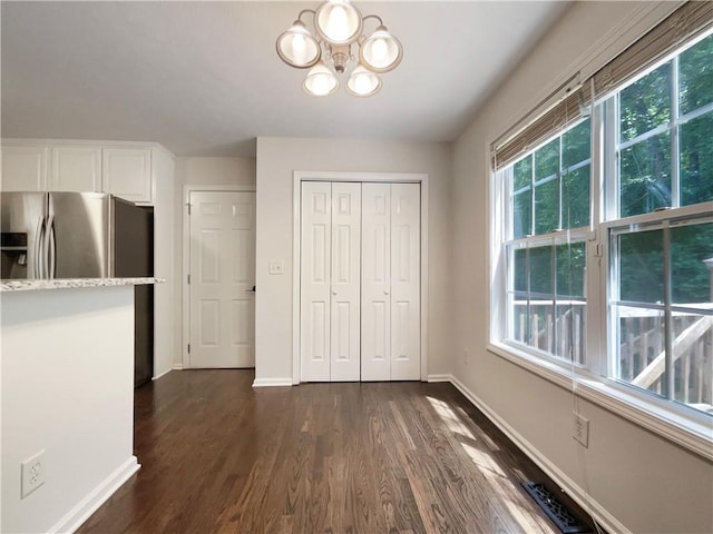 6001 Deer Springs Ln NW, Acworth, GA 30101 - unfurnished dining area featuring dark wood-type flooring, a chandelier, and baseboards