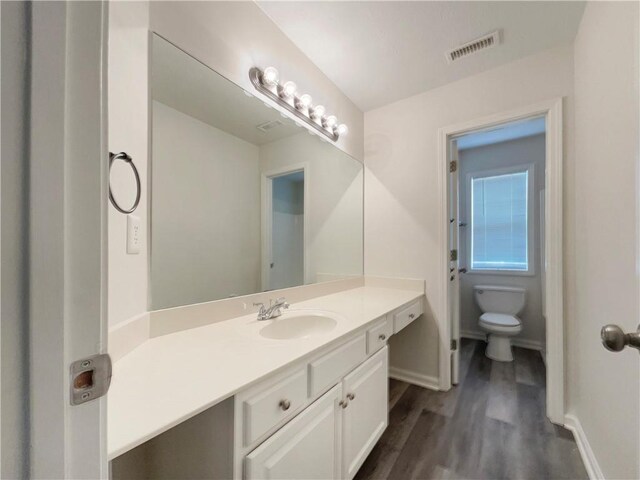 6001 Deer Springs Ln NW, Acworth, GA 30101 - bathroom featuring toilet, vanity, wood finished floors, and baseboards