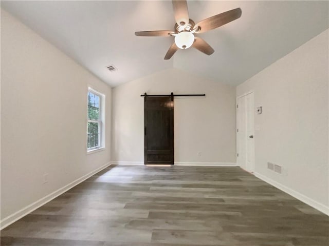 6001 Deer Springs Ln NW, Acworth, GA 30101 - spare room with a barn door, ceiling fan, wood finished floors, lofted ceiling, and baseboards