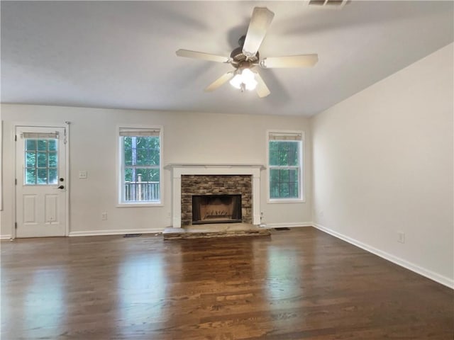 6001 Deer Springs Ln NW, Acworth, GA 30101 - unfurnished living room with wood finished floors, baseboards, ceiling fan, and a stone fireplace