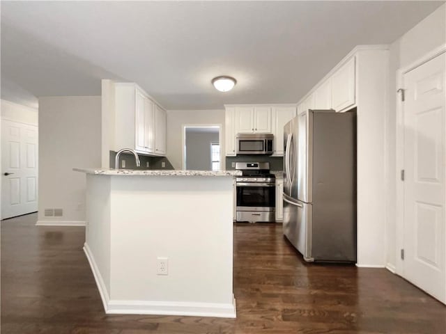 6001 Deer Springs Ln NW, Acworth, GA 30101 - kitchen featuring stainless steel appliances, a peninsula, and white cabinetry