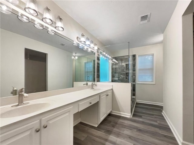 6001 Deer Springs Ln NW, Acworth, GA 30101 - bathroom with a stall shower, double vanity, wood finished floors, and baseboards