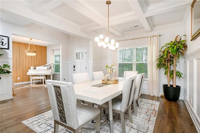 dining area featuring beamed ceiling, dark hardwood / wood-style floors, a wealth of natural light, and a chandelier