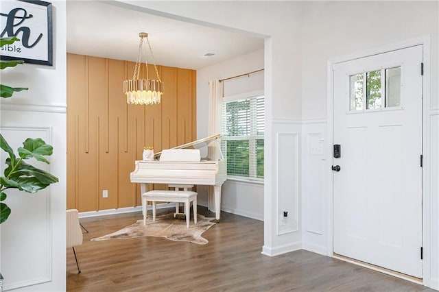 foyer with hardwood / wood-style floors, an inviting chandelier, and a healthy amount of sunlight