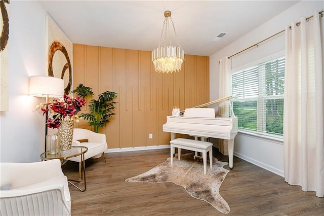 living area featuring dark wood-type flooring and a notable chandelier