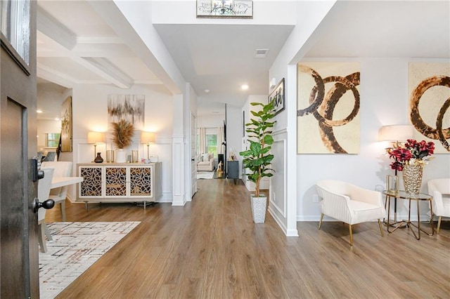 foyer entrance featuring beam ceiling and wood-type flooring