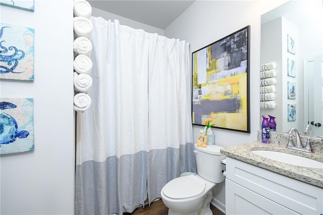 bathroom with hardwood / wood-style floors, vanity, toilet, and a shower with shower curtain