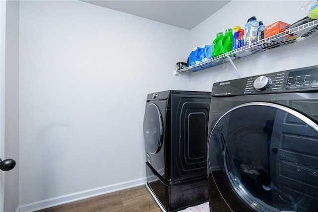 laundry room featuring dark hardwood / wood-style flooring and independent washer and dryer