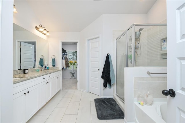 bathroom featuring tile patterned flooring, vanity, and shower with separate bathtub