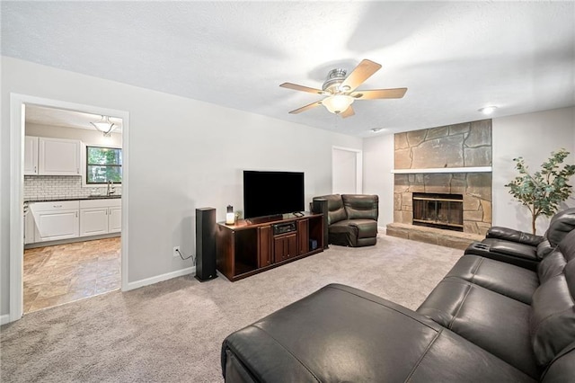 7060 Steel Wood Dr NW, Kennesaw, GA 30152 - living area featuring light carpet, ceiling fan, a fireplace, and baseboards