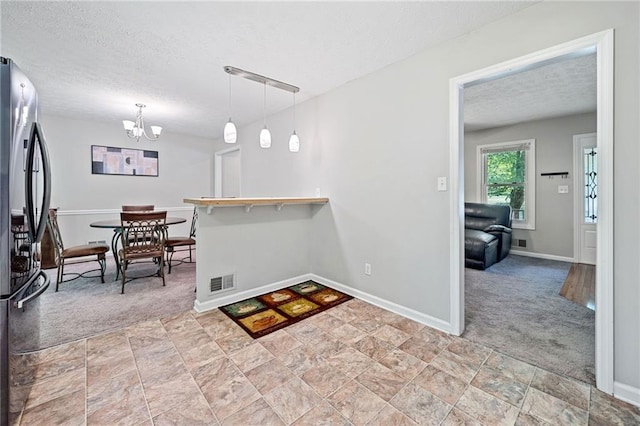 7060 Steel Wood Dr NW, Kennesaw, GA 30152 - kitchen with freestanding refrigerator, light carpet, a textured ceiling, a chandelier, and baseboards