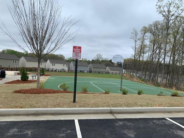 300 Hyde Park, Winder, GA 30680 - back of property with a lawn, brick siding, fence, and cooling unit