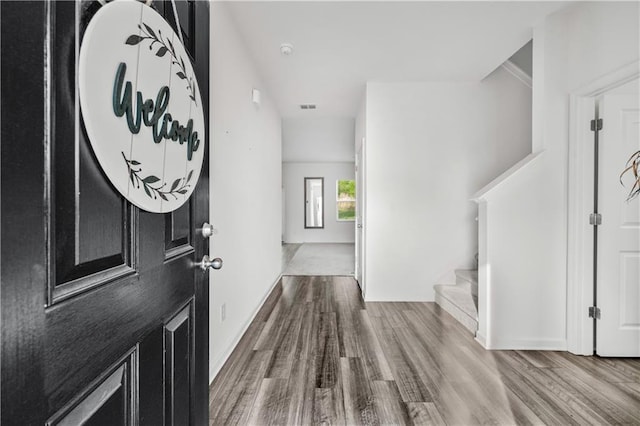 300 Hyde Park, Winder, GA 30680 - hall featuring dark wood-type flooring, stairs, baseboards, and visible vents