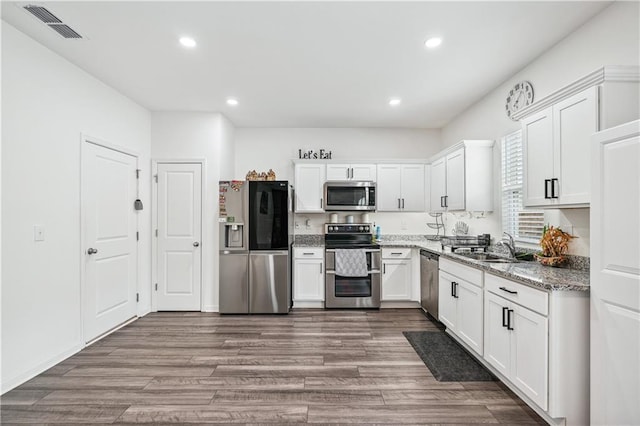 300 Hyde Park, Winder, GA 30680 - kitchen with visible vents, dark wood-style floors, stainless steel appliances, recessed lighting, and white cabinetry