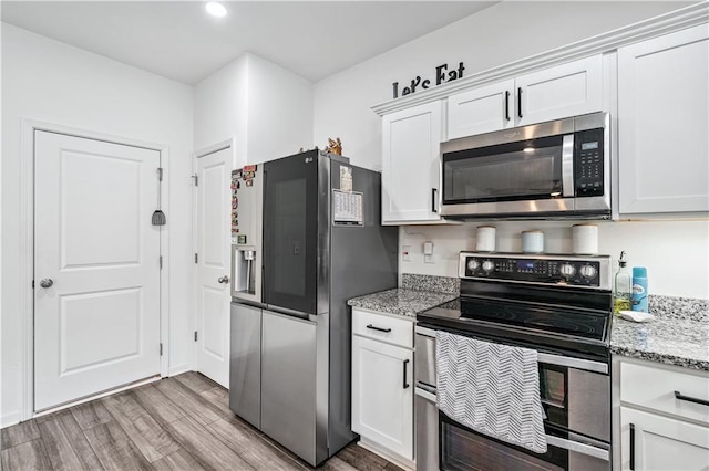 300 Hyde Park, Winder, GA 30680 - kitchen with dark wood-style flooring, stone countertops, recessed lighting, white cabinetry, and appliances with stainless steel finishes