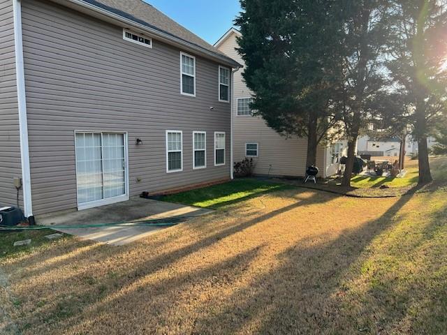 back of house with a lawn