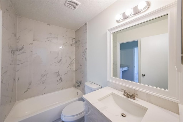 full bathroom with vanity, toilet, tiled shower / bath combo, and a textured ceiling