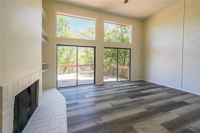 living room featuring a high ceiling, dark hardwood / wood-style floors, and ceiling fan