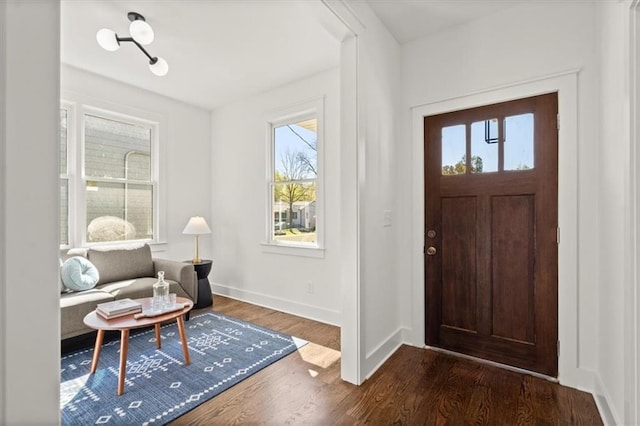 entryway featuring dark wood-style floors and baseboards