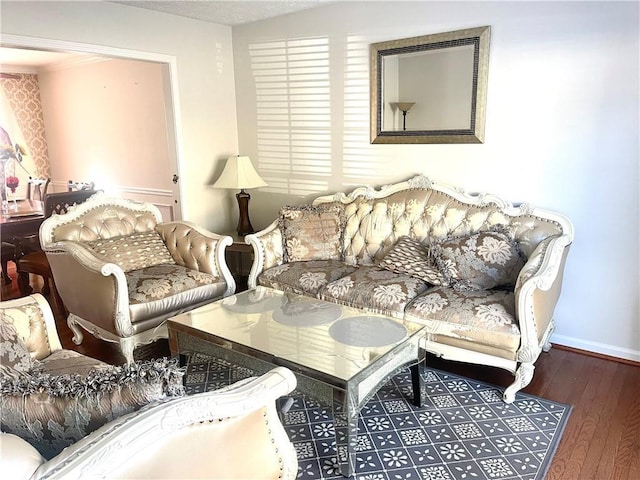 living room with baseboards and wood finished floors