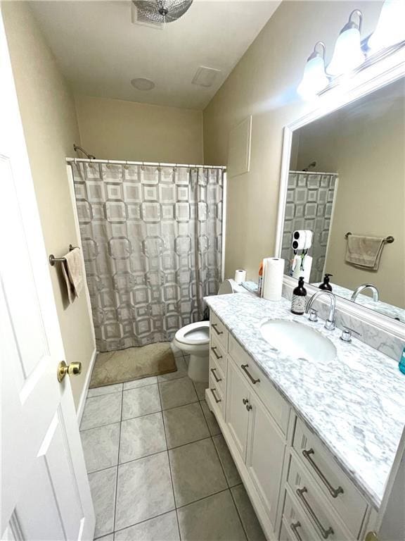 bathroom with tile patterned flooring, a shower with shower curtain, vanity, and toilet