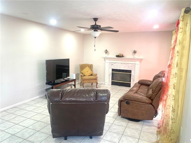 living room featuring light tile patterned floors, baseboards, a high end fireplace, a ceiling fan, and recessed lighting