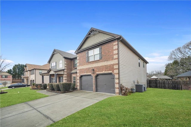 view of front of home with central AC unit, a garage, and a front lawn