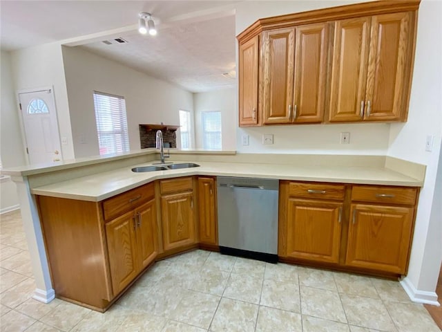 kitchen with stainless steel dishwasher, kitchen peninsula, sink, and light tile patterned floors