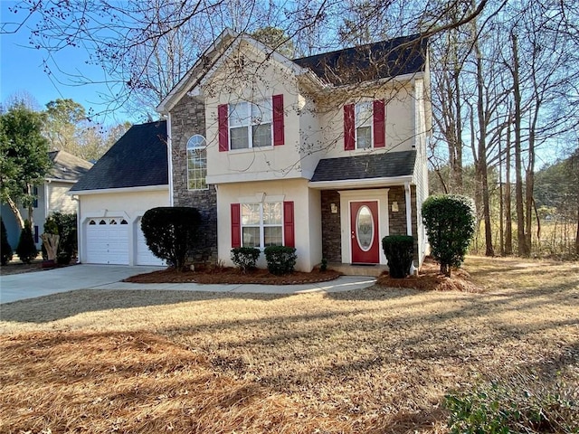 view of front property featuring a garage and a front yard