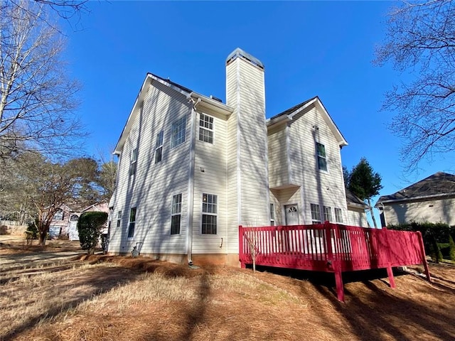 back of property featuring a deck