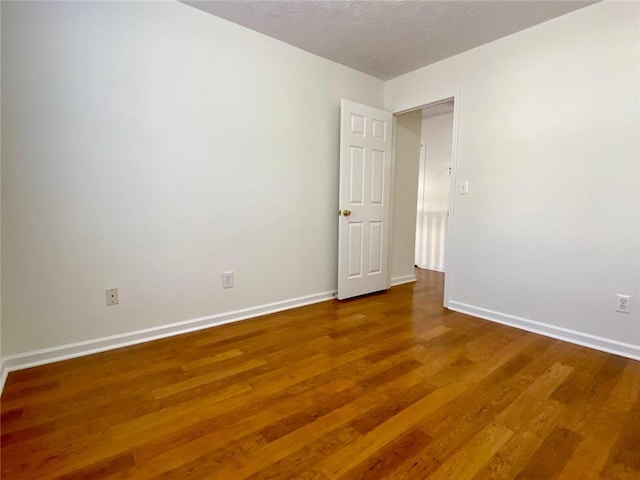 empty room featuring hardwood / wood-style floors and a textured ceiling