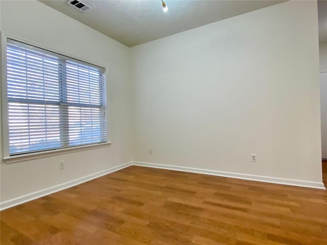 spare room with wood-type flooring