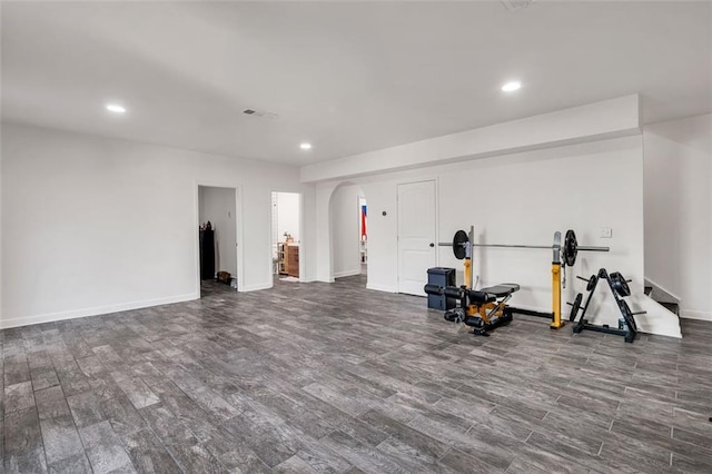 workout area with dark hardwood / wood-style floors