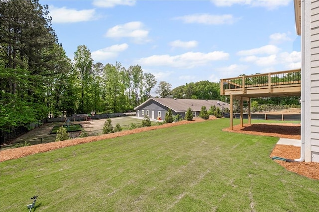 view of yard with driveway and a deck